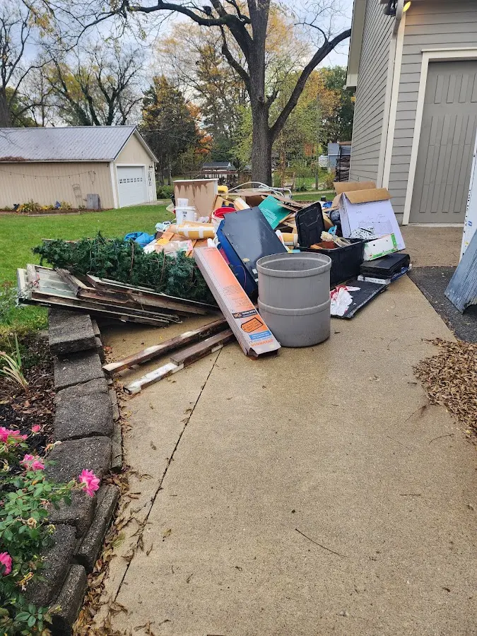 Dumpster being loaded with debris for Residential Dumpster Rental in Felton